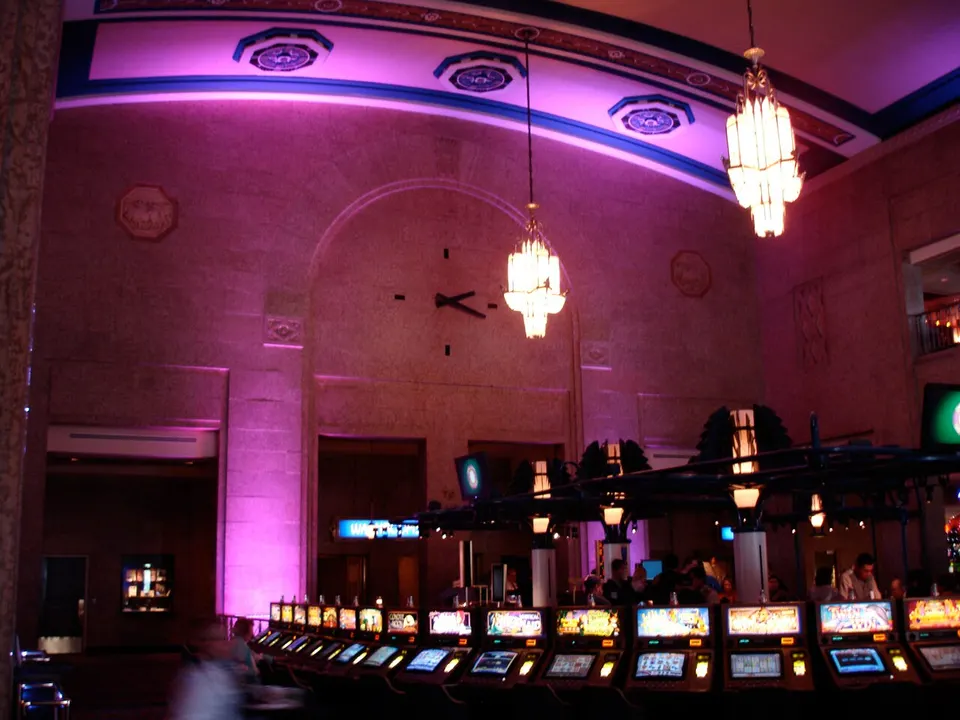 Old station concourse with chandeliers above slot machines